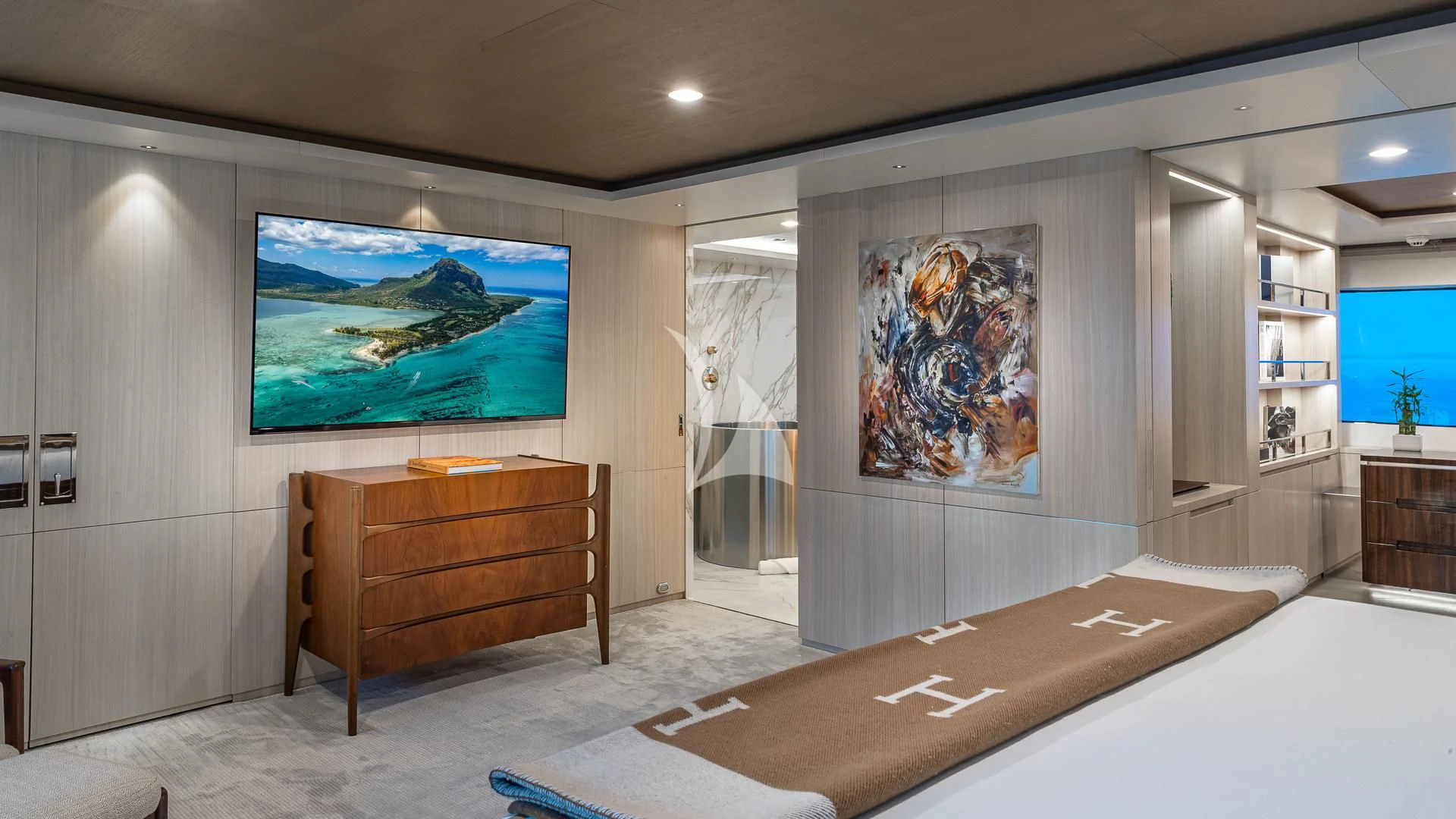 a room with a tv and a table aboard REVERIE Yacht for Sale