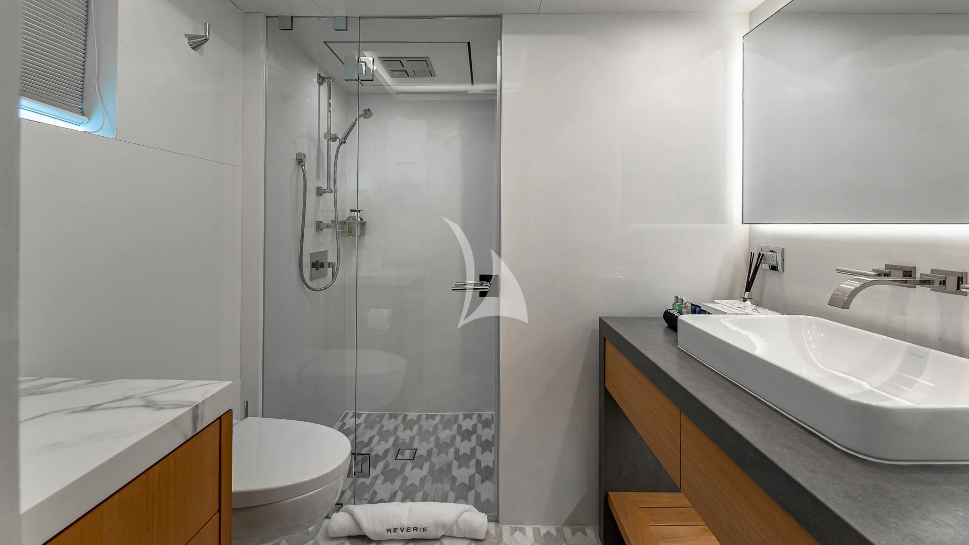 a bathroom with a shower sink and toilet aboard REVERIE Yacht for Sale