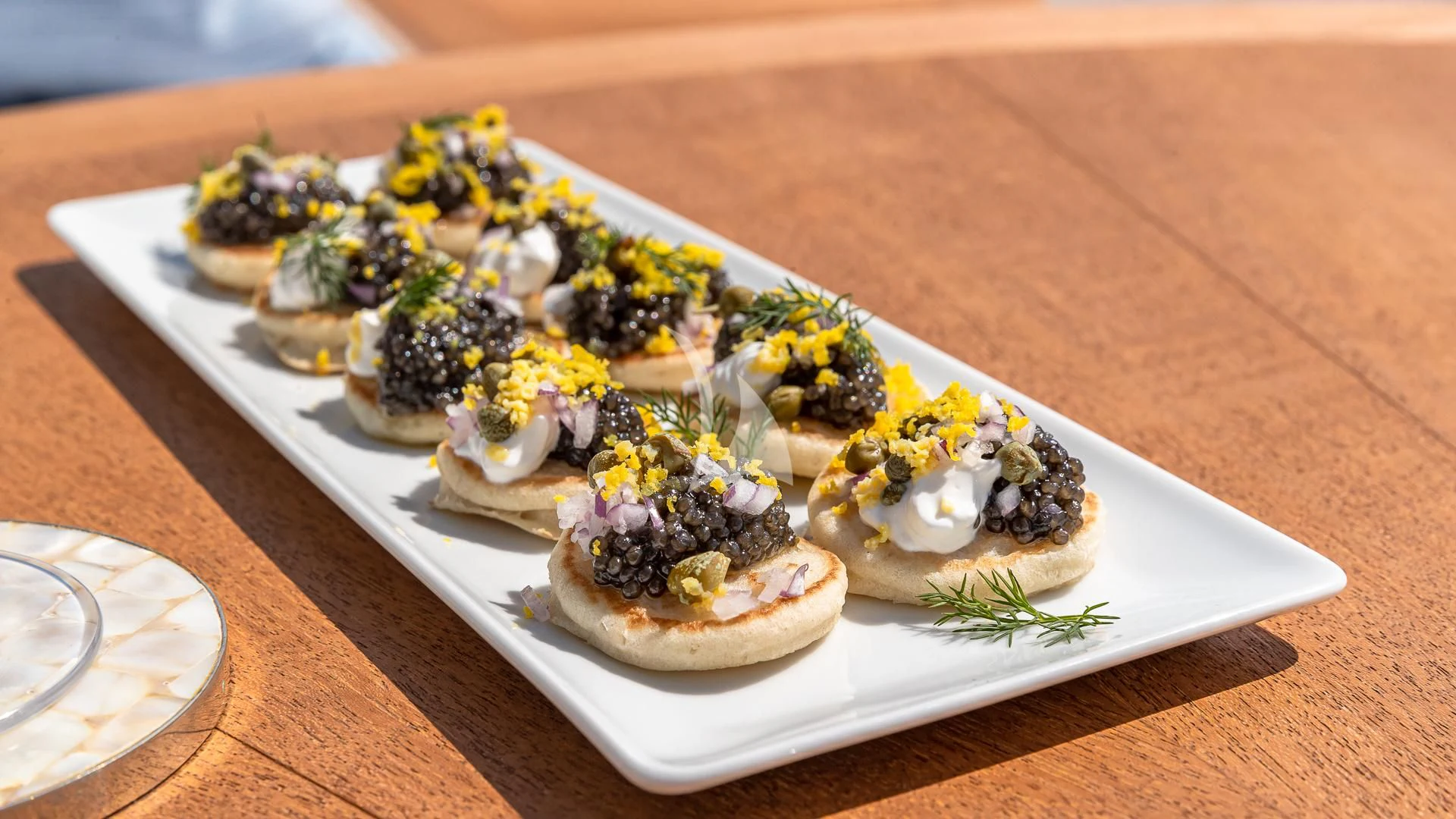 a plate of sushi aboard REVERIE Yacht for Sale