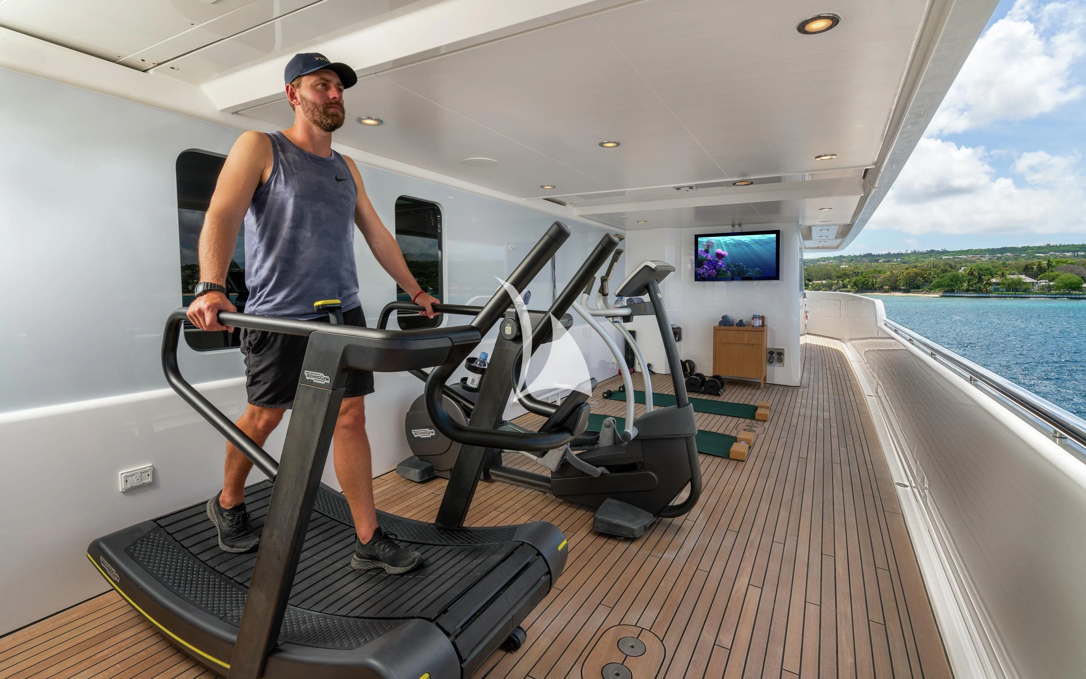 a man standing on a treadmill aboard REVERIE Yacht for Sale