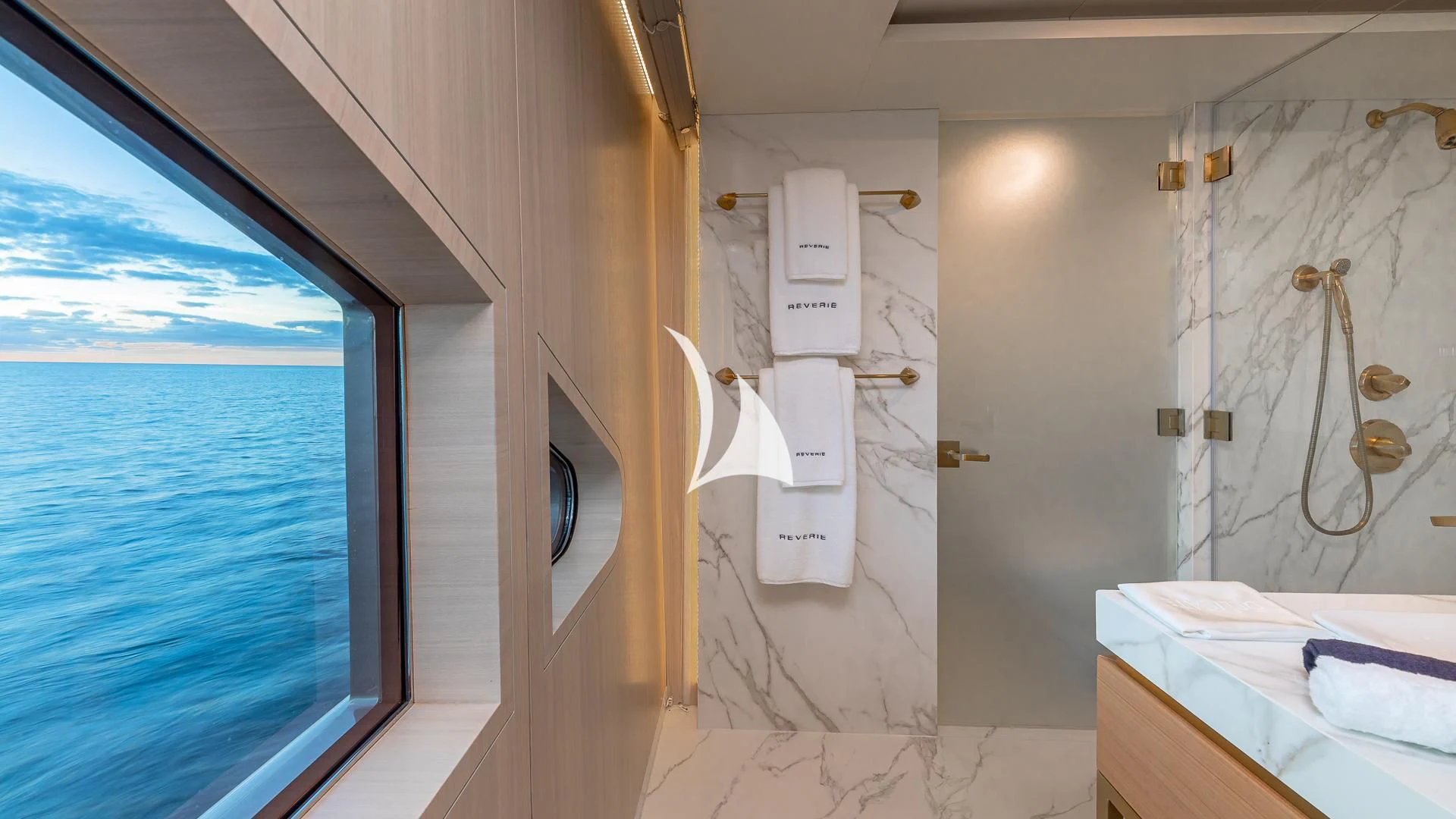 a room with a window and a sink with a view of the ocean aboard REVERIE Yacht for Sale