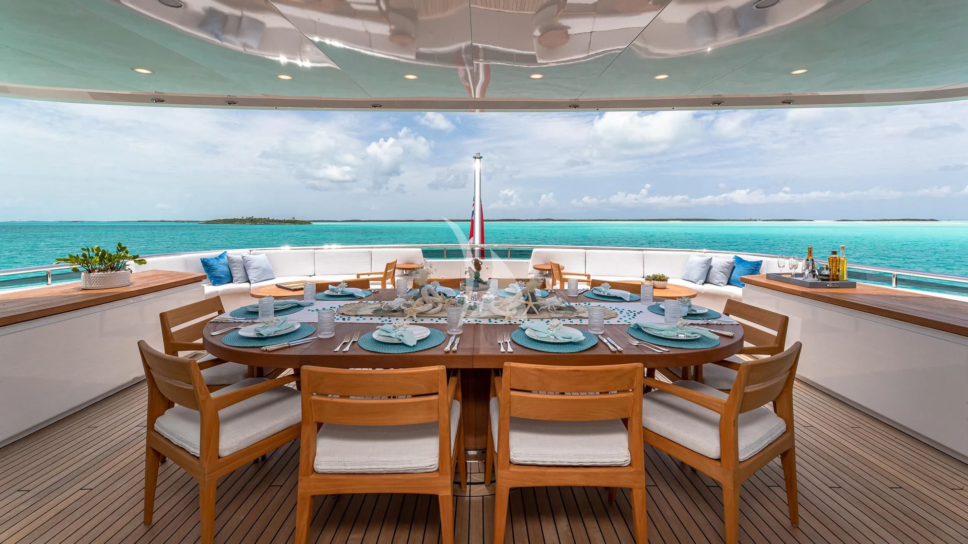 a table set for a meal on a balcony overlooking the ocean aboard REVERIE Yacht for Sale