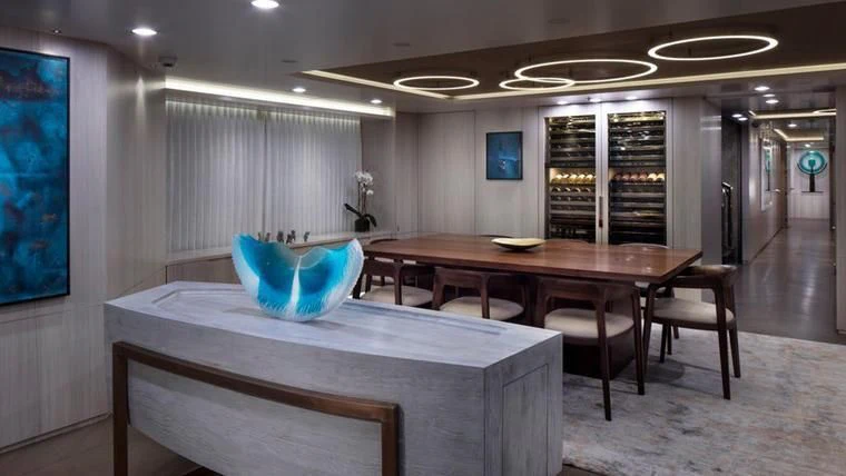 a room with a table and chairs aboard REVERIE Yacht for Sale