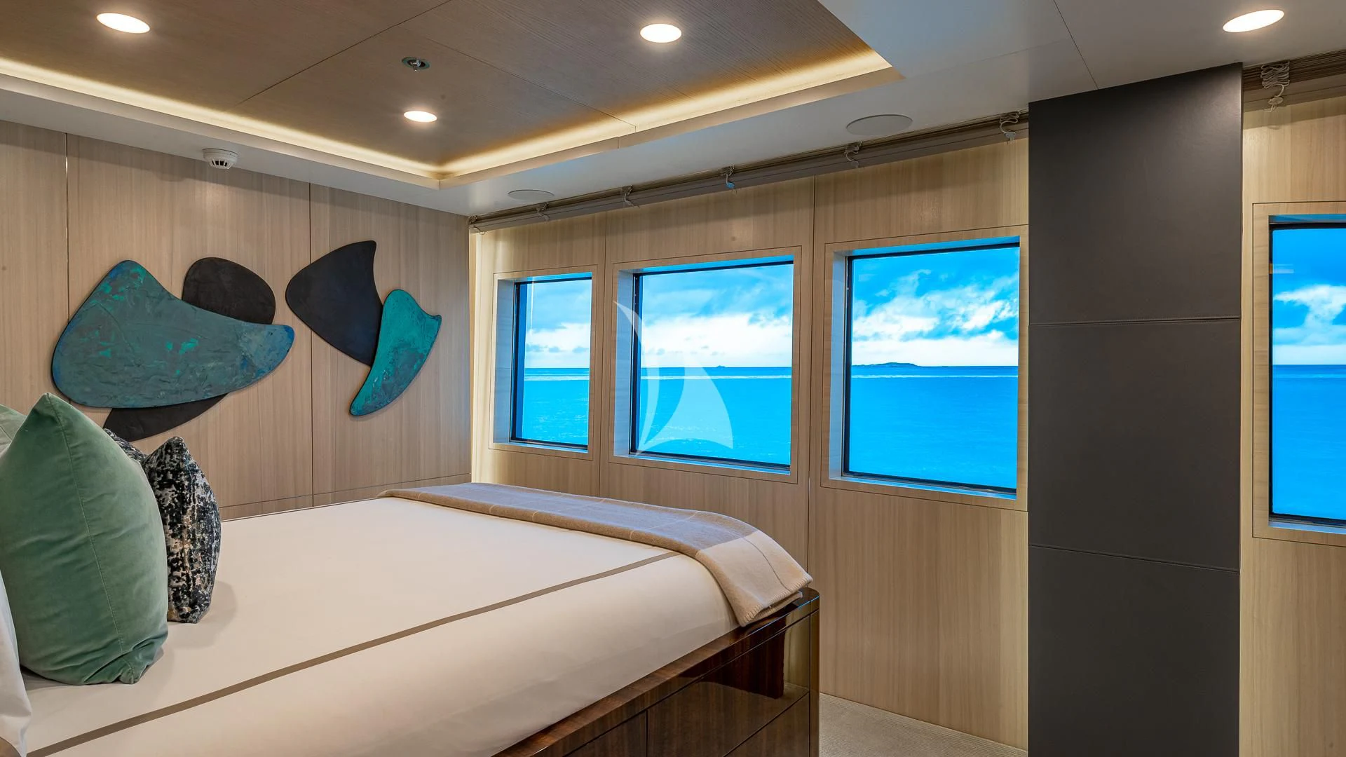 a bedroom with a bed and a window aboard REVERIE Yacht for Sale