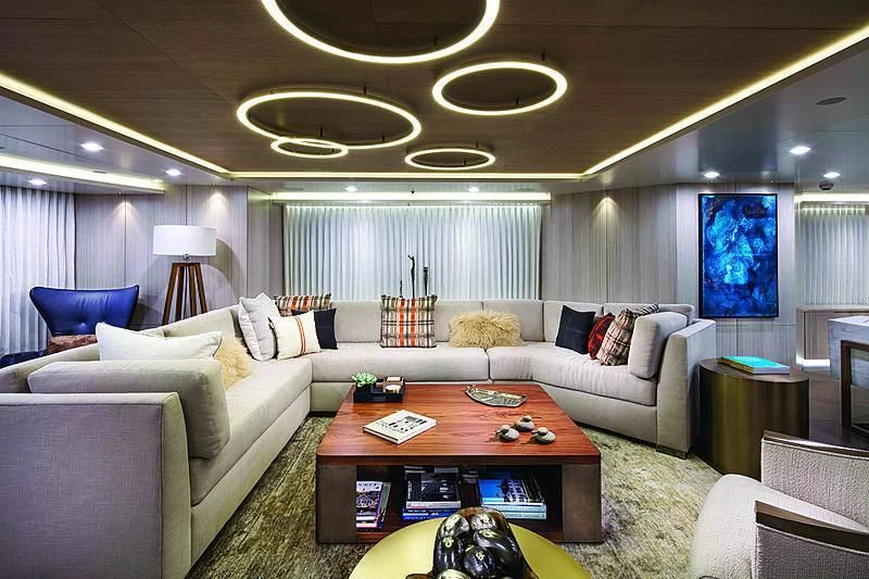 a living room with a large chandelier aboard REVERIE Yacht for Sale