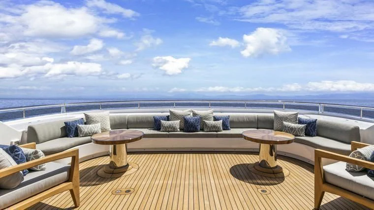 a large patio with a large body of water in the background aboard REVERIE Yacht for Sale