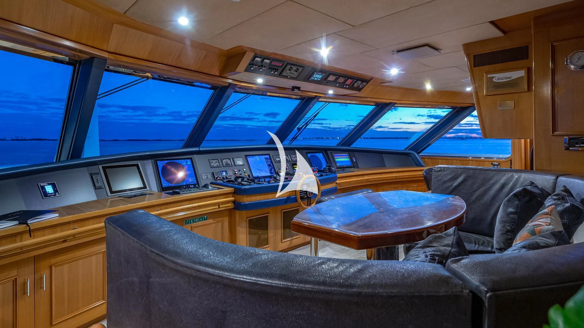 a room with a couch and a table with a laptop on it aboard REVERIE Yacht for Sale