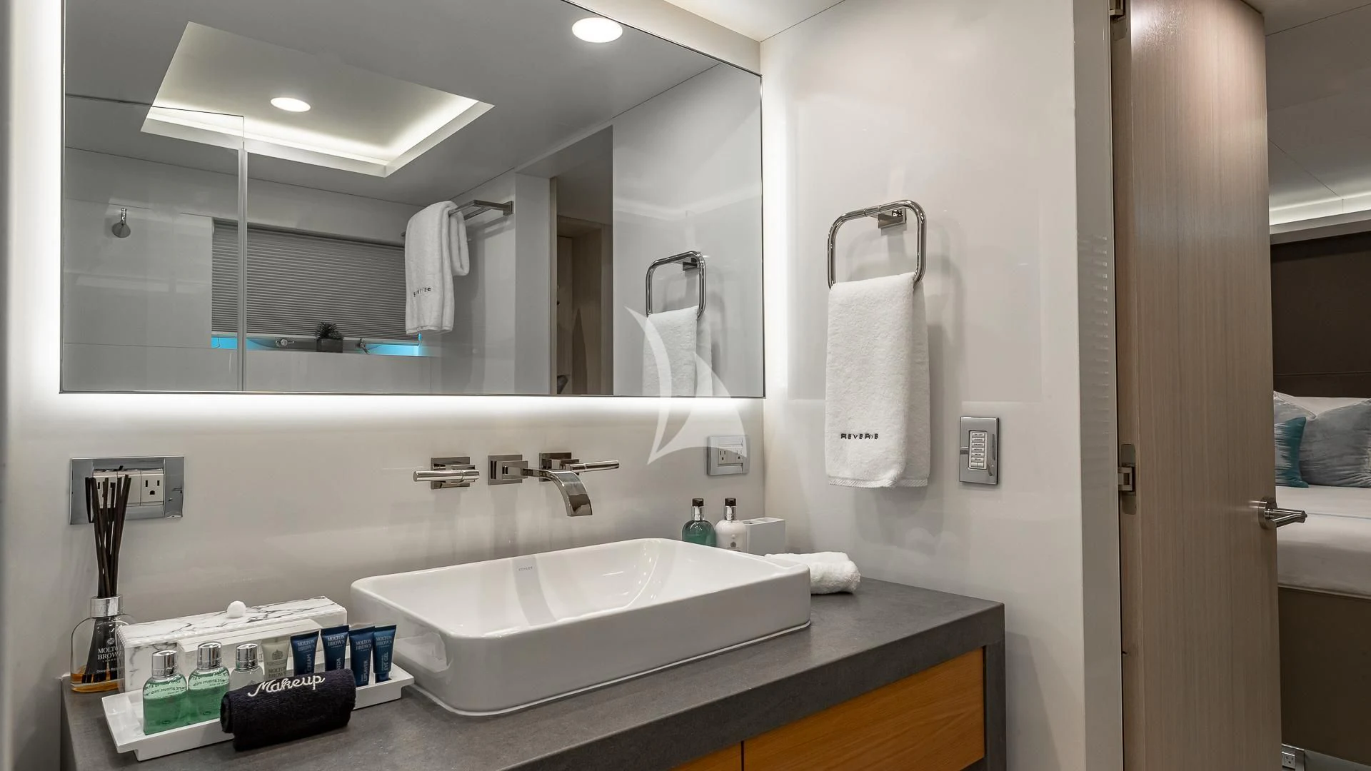 a bathroom with a large mirror aboard REVERIE Yacht for Sale