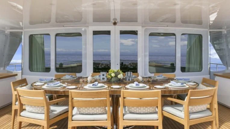 a dining room with a table set aboard REVERIE Yacht for Sale