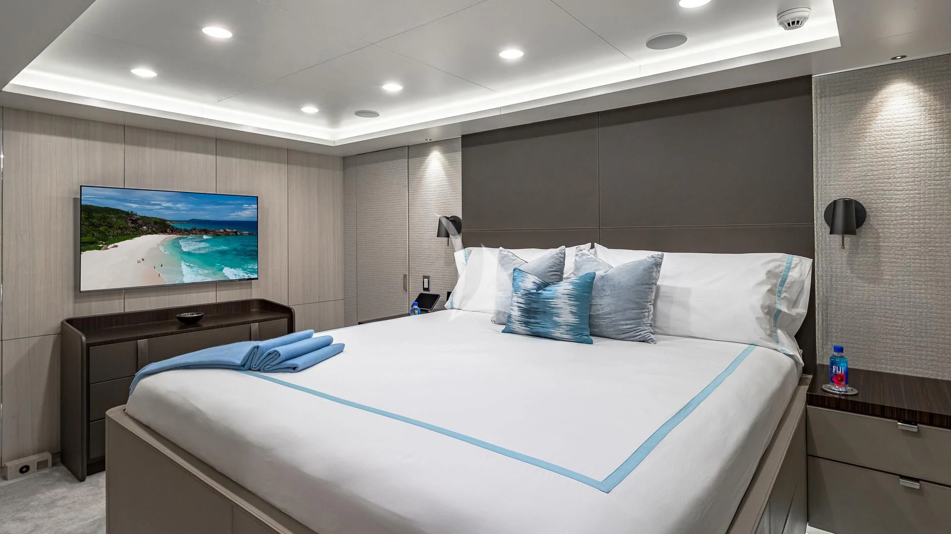 a bed with blue sheets aboard REVERIE Yacht for Sale