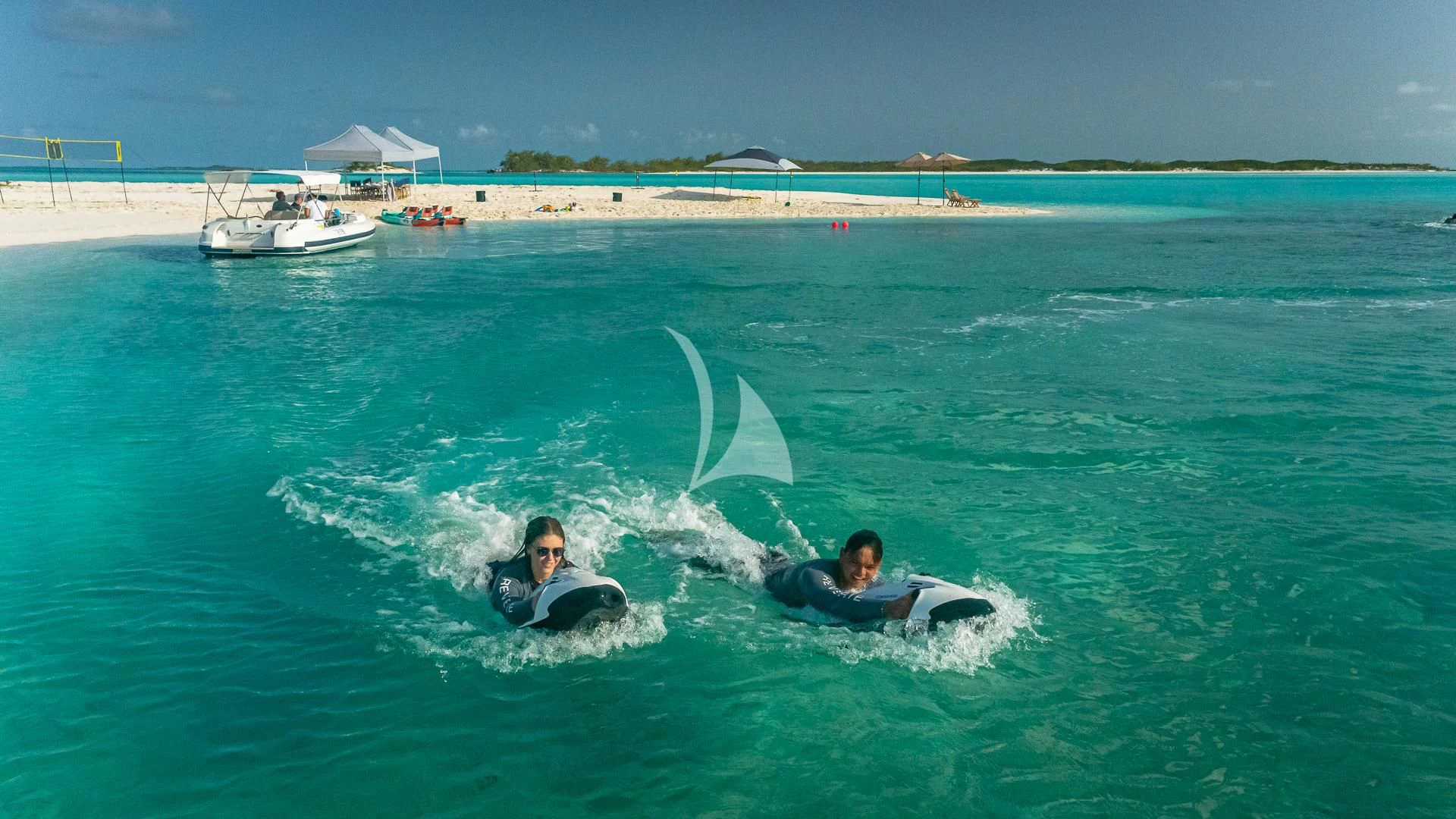 a person riding a surfboard in the ocean aboard REVERIE Yacht for Sale