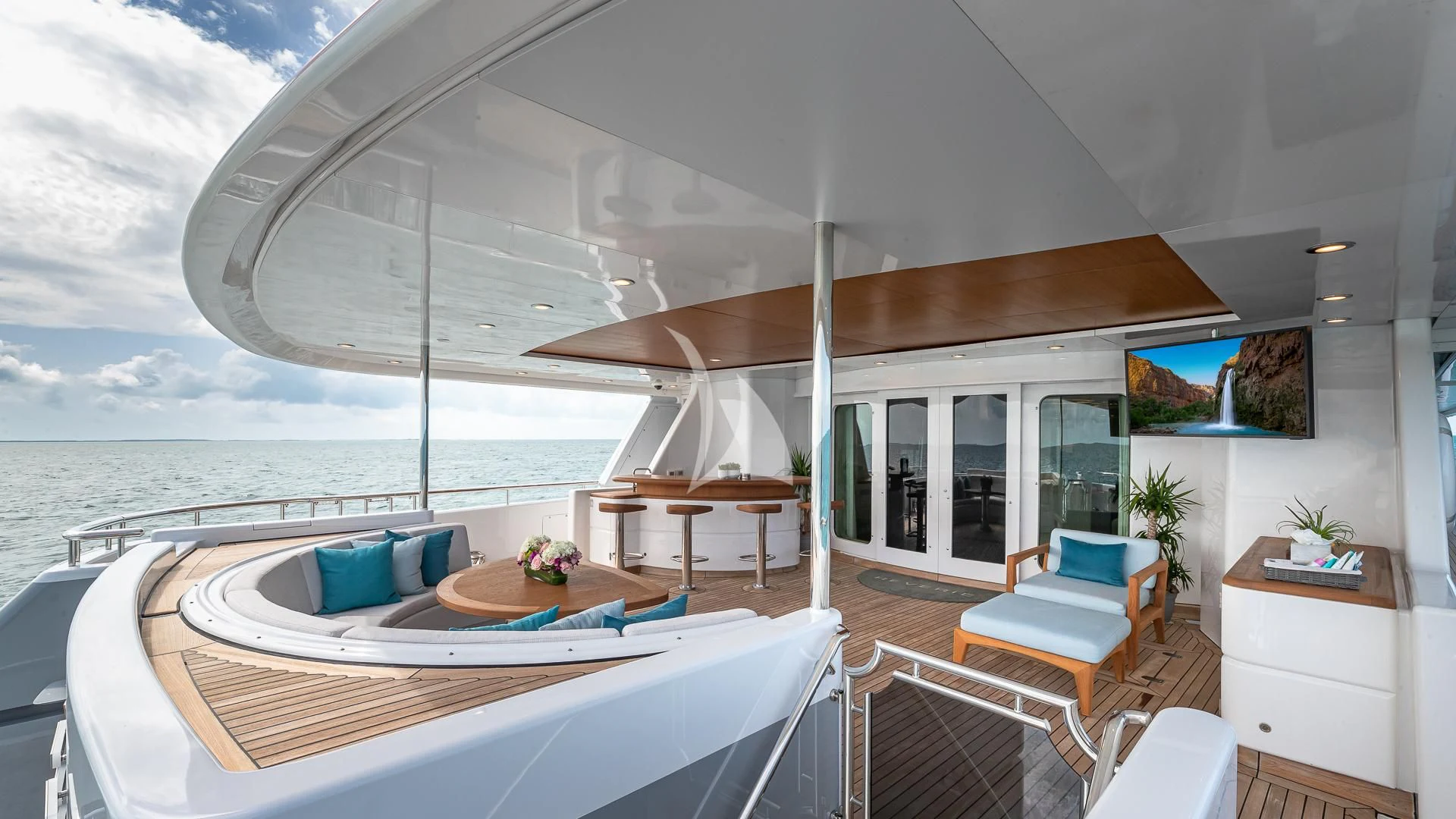 a large white lounge chair on a balcony overlooking a large body of water aboard REVERIE Yacht for Sale