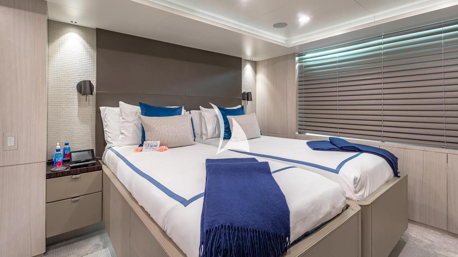 a bed with blue and white sheets aboard REVERIE Yacht for Sale