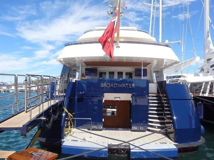 a boat with a flag on the front aboard REVERIE Yacht for Sale