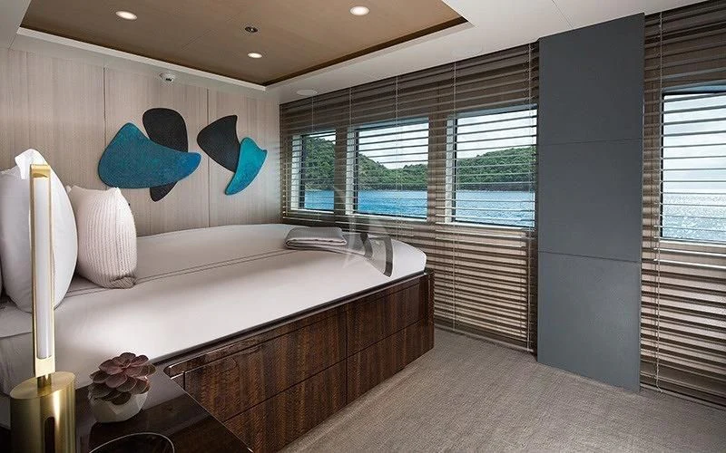 a large white bed in a room aboard REVERIE Yacht for Sale