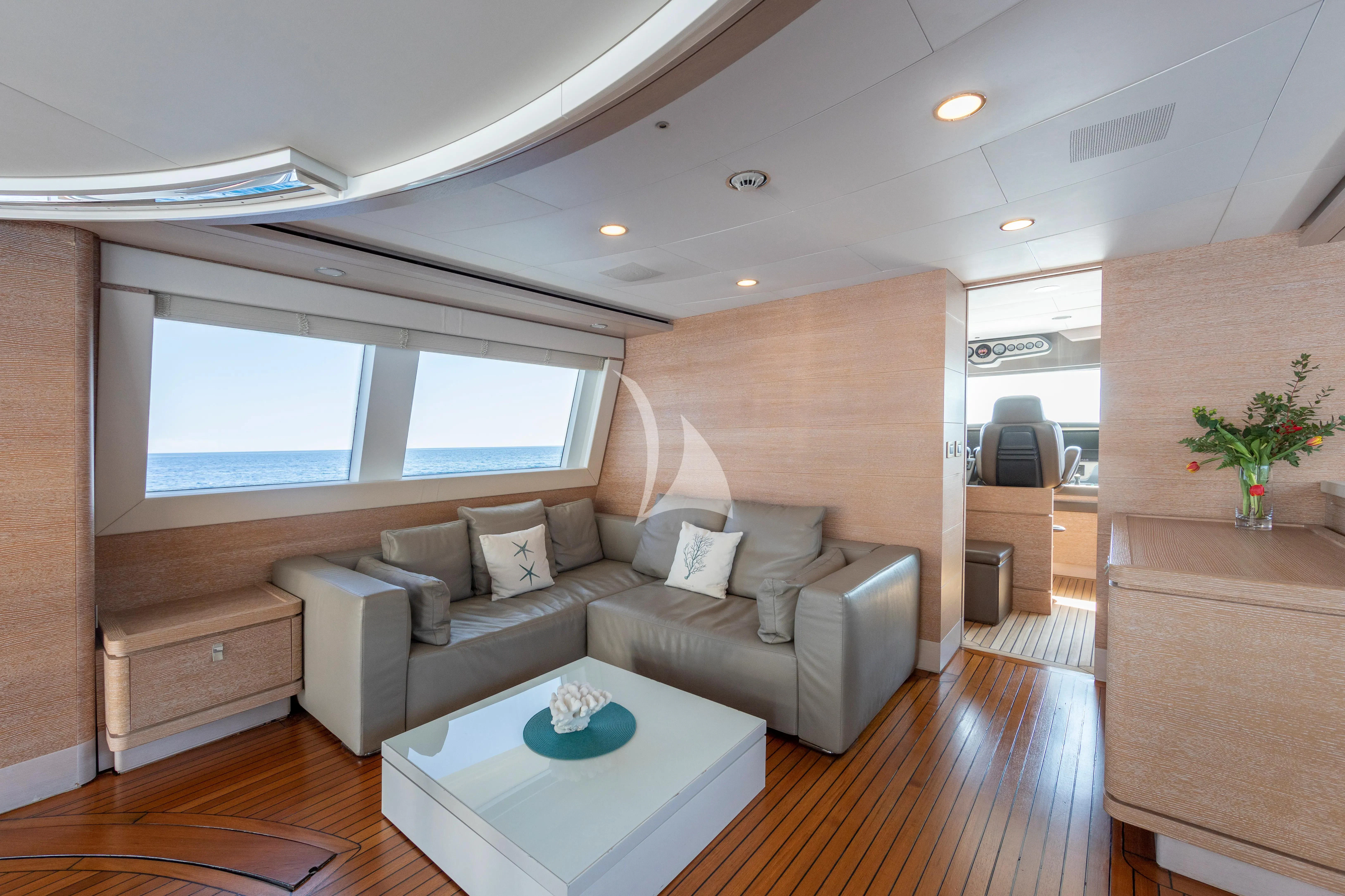 a living room with a couch and a table aboard CENTURION Yacht for Sale