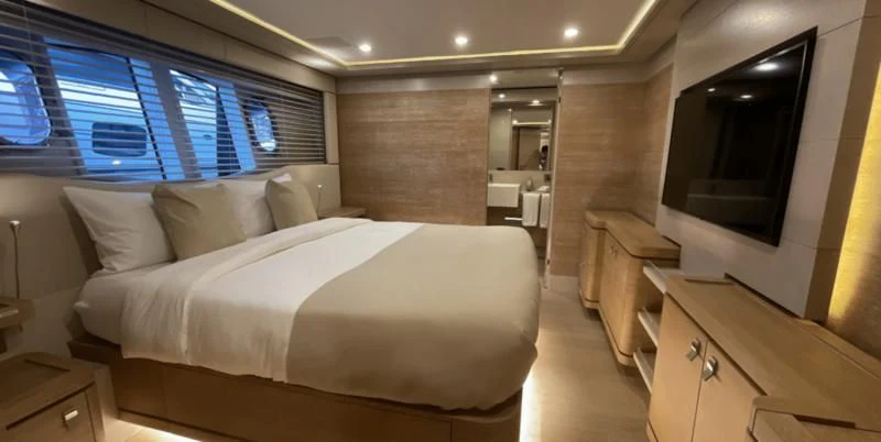 a room with a bed and a television aboard CENTURION Yacht for Sale