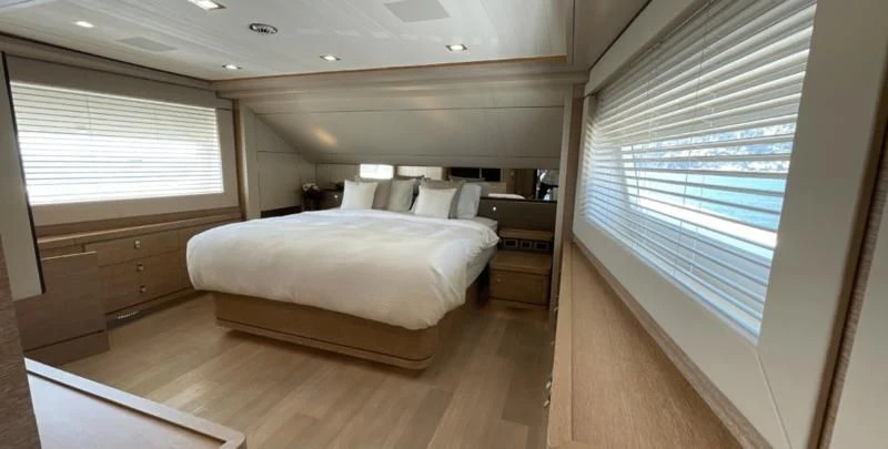 a room with a bed and a window aboard CENTURION Yacht for Sale