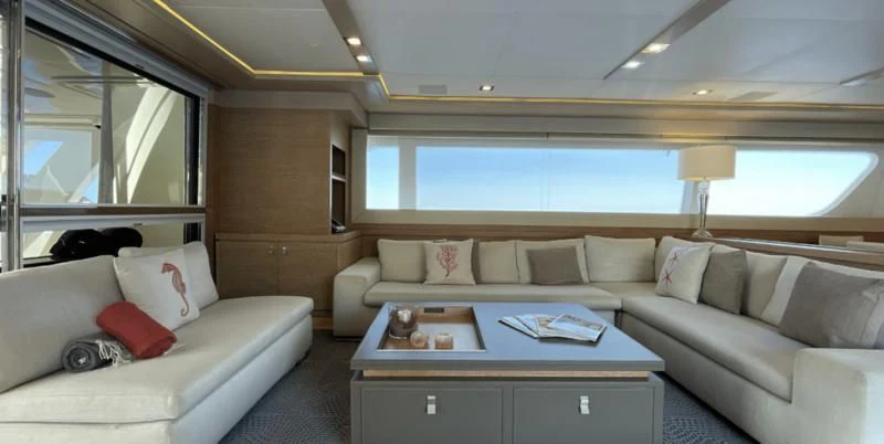 a living room with a couch and a table aboard CENTURION Yacht for Sale