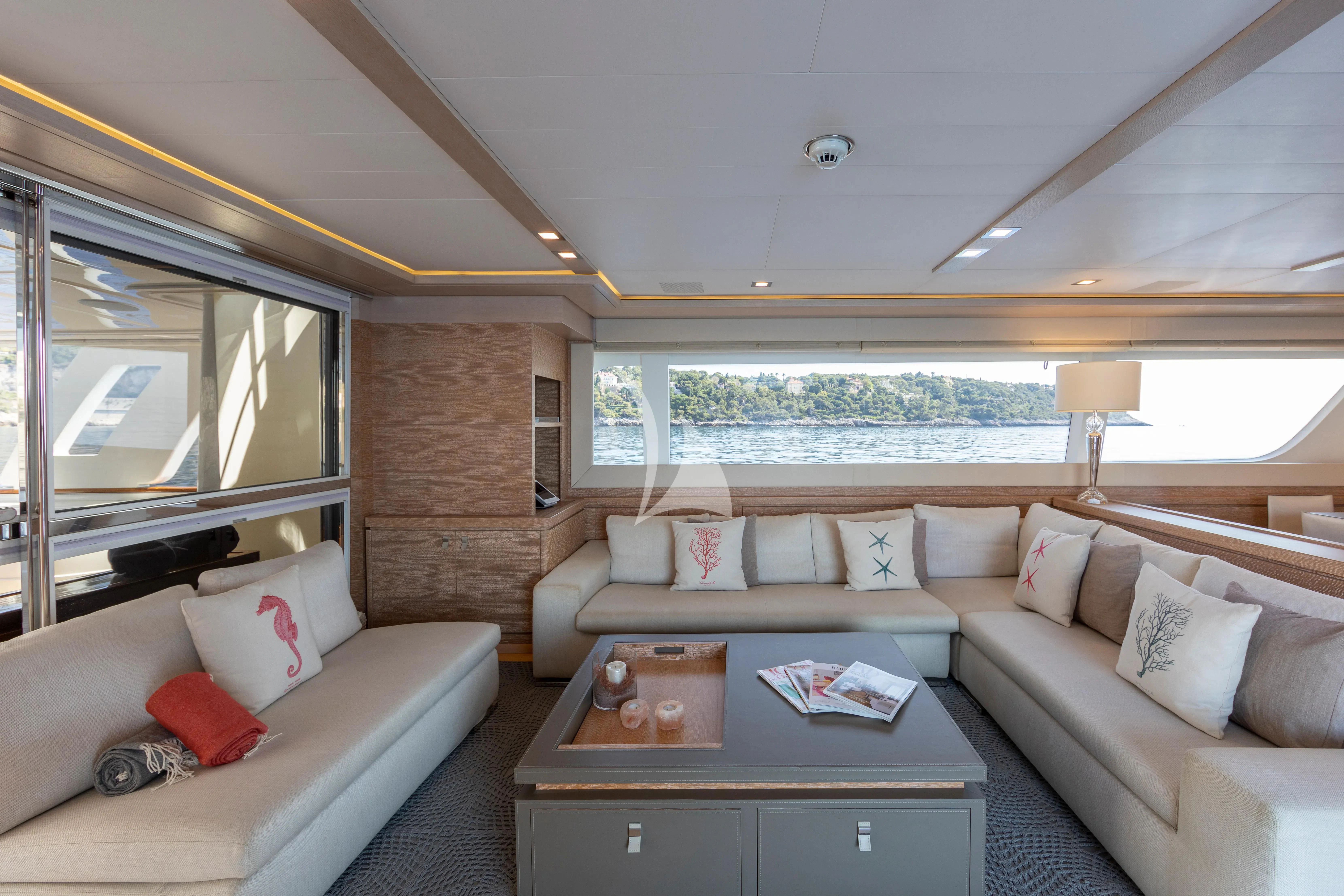 a living room with a couch and a table aboard CENTURION Yacht for Sale