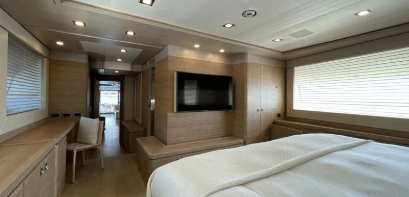 a room with a bed and a television aboard CENTURION Yacht for Sale