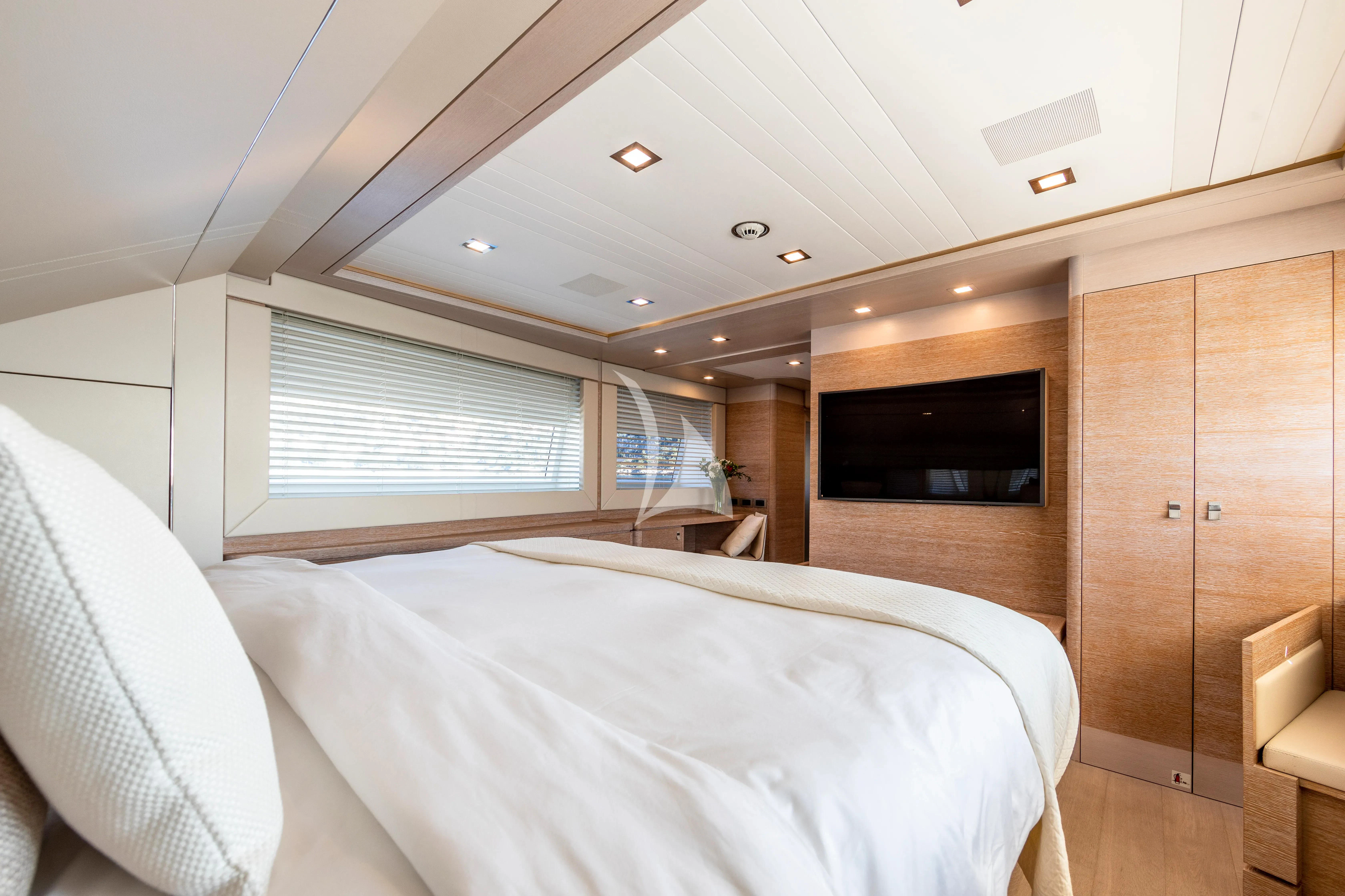 a room with a bed and a television aboard CENTURION Yacht for Sale
