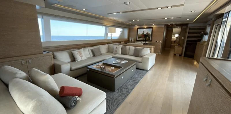 a living room with a couch and a coffee table aboard CENTURION Yacht for Sale