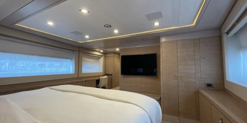 a room with a bed and a television aboard CENTURION Yacht for Sale