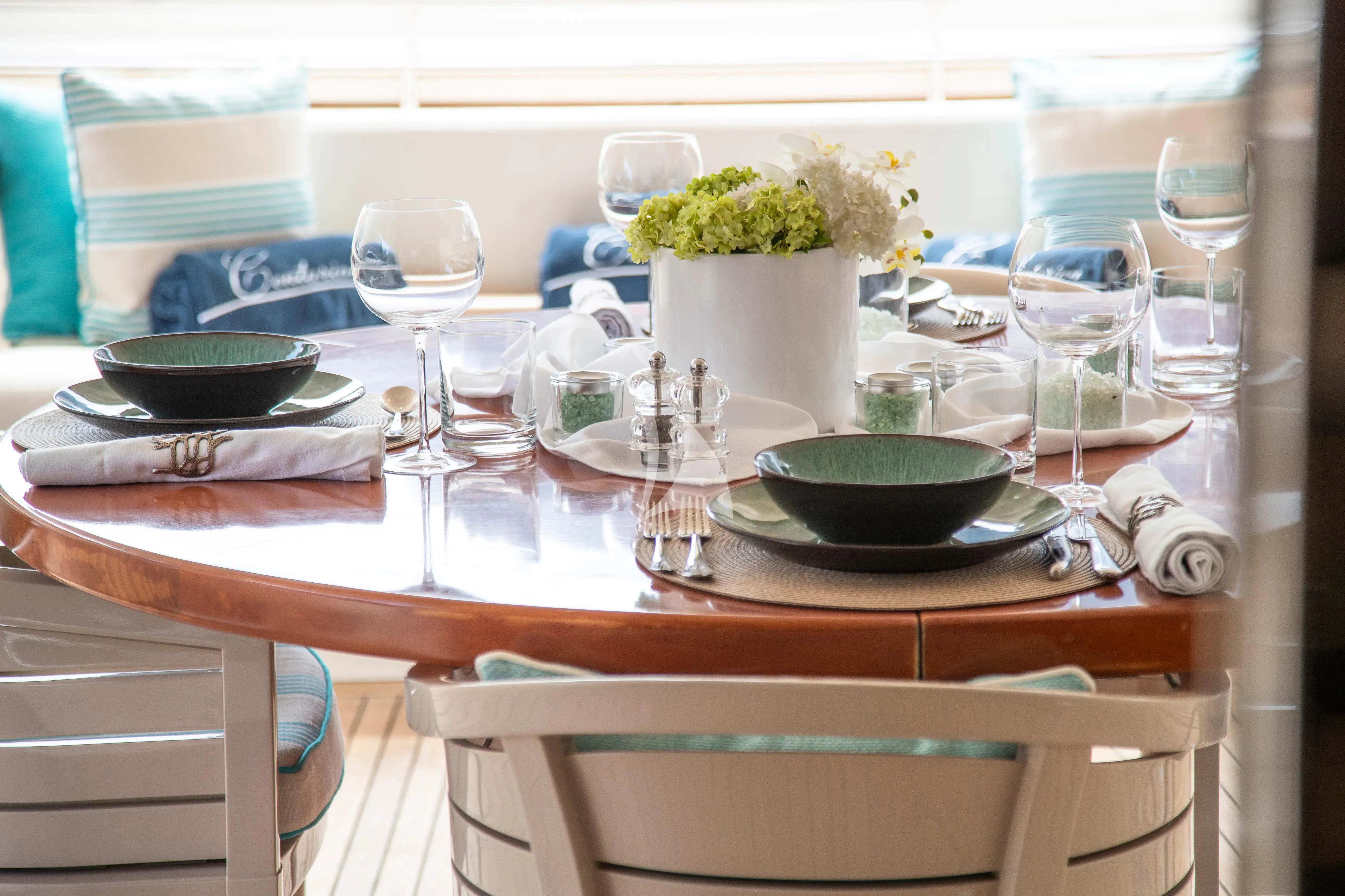 a table with plates and glasses aboard CENTURION Yacht for Sale