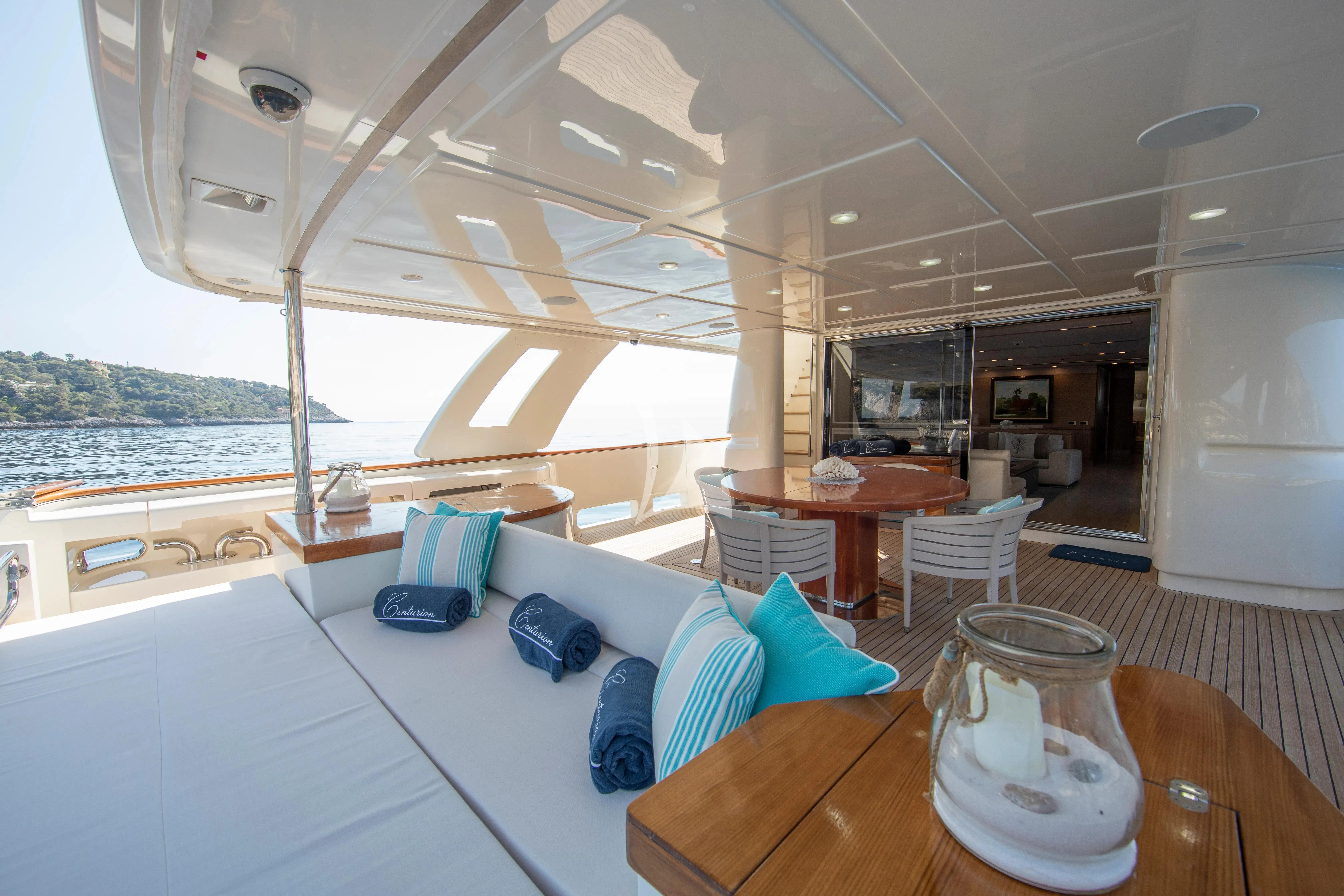 a large room with a table and chairs and a large window aboard CENTURION Yacht for Sale