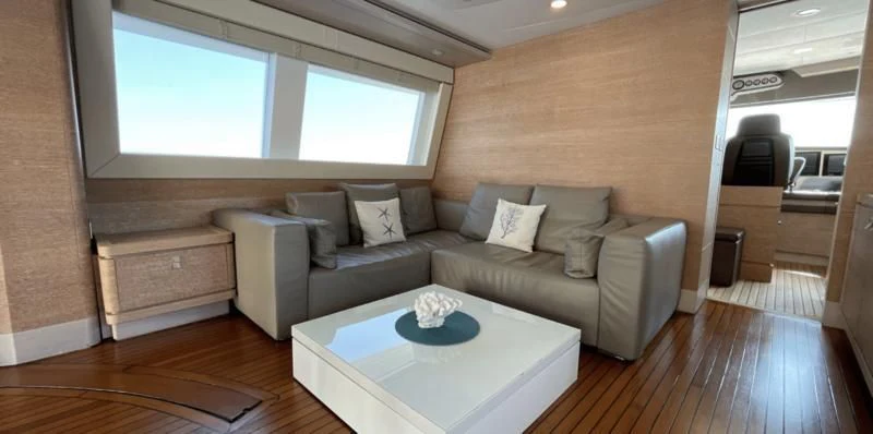 a living room with a couch and a table aboard CENTURION Yacht for Sale