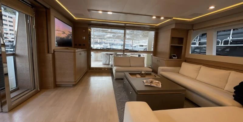 a living room with a tv and sofas aboard CENTURION Yacht for Sale