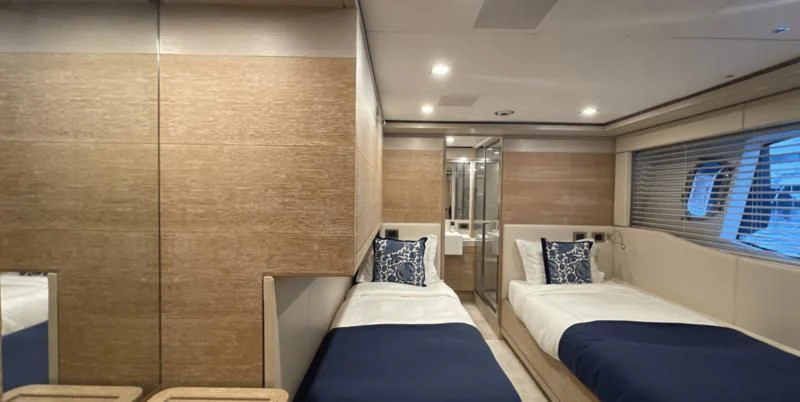 a room with beds and a mirror aboard CENTURION Yacht for Sale