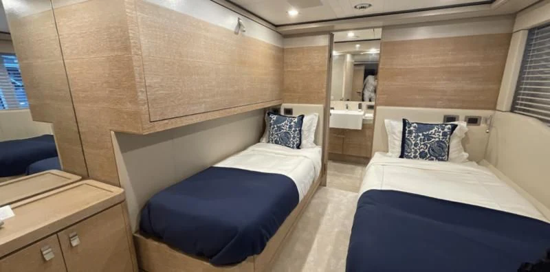 a room with two beds aboard CENTURION Yacht for Sale