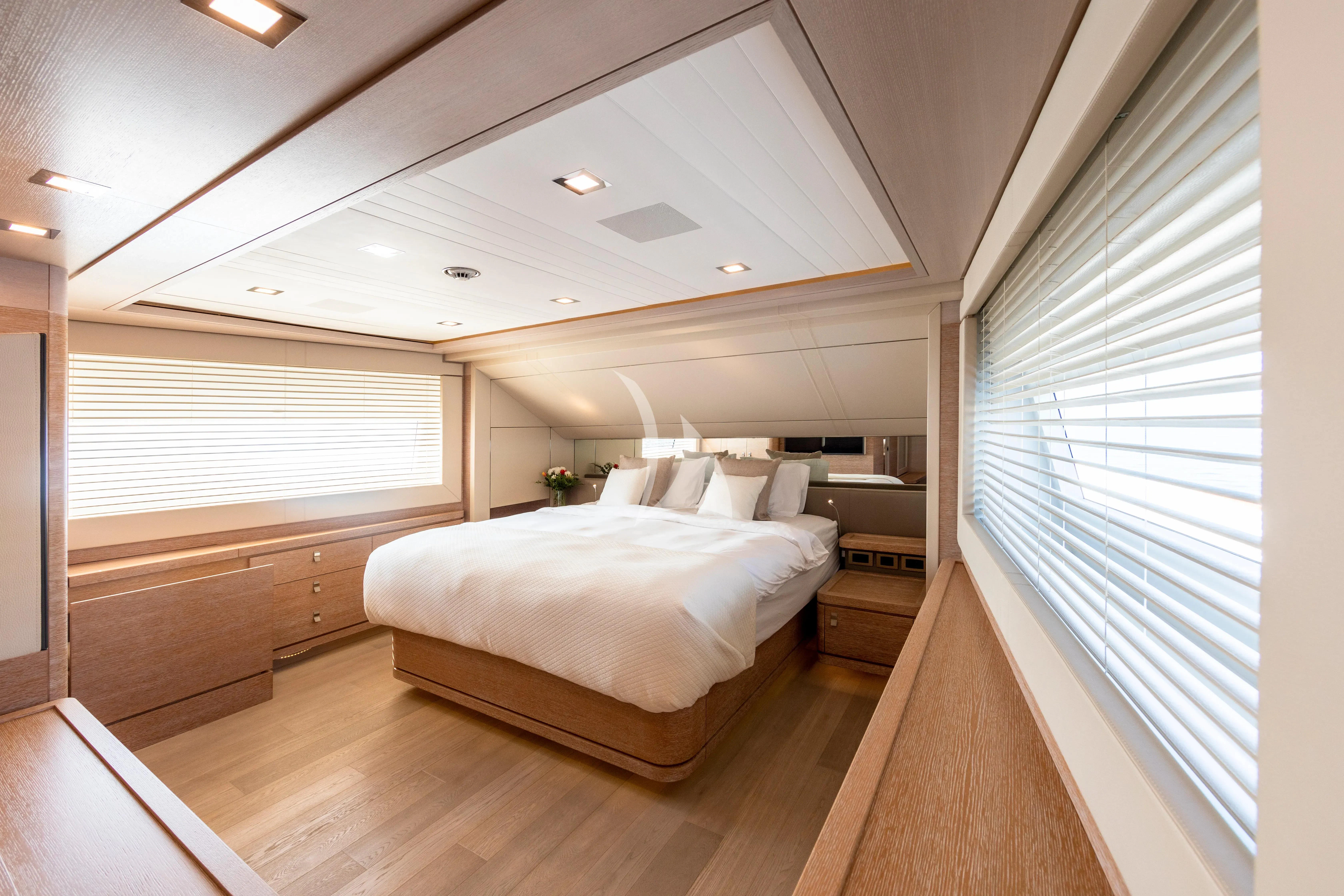 a room with a bed and a window aboard CENTURION Yacht for Sale