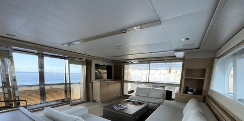 a living room with a large window aboard CENTURION Yacht for Sale