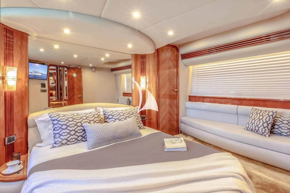 a room with a bed and a couch aboard MANU Yacht for Charter
