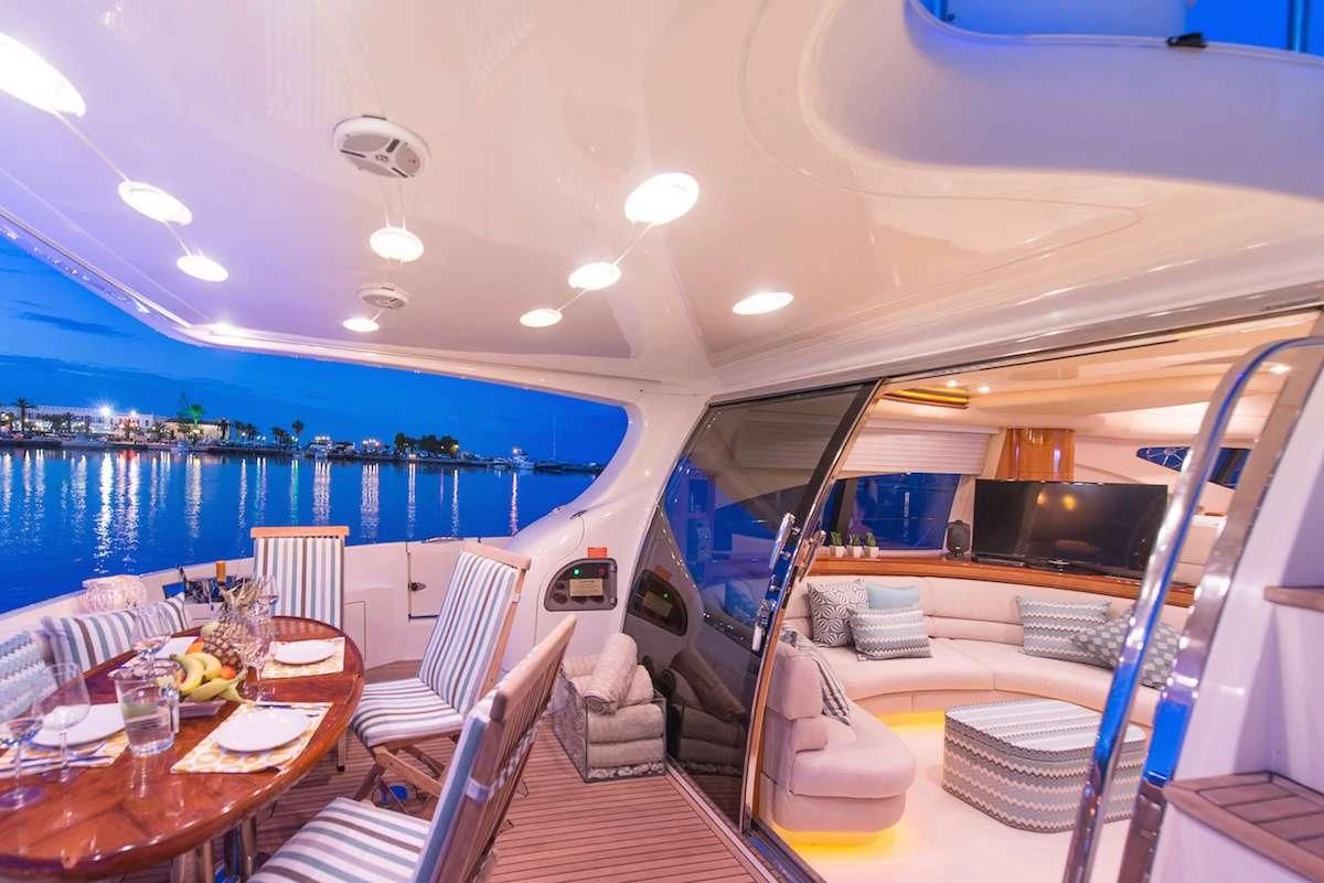 a boat with a table and chairs aboard MANU Yacht for Charter