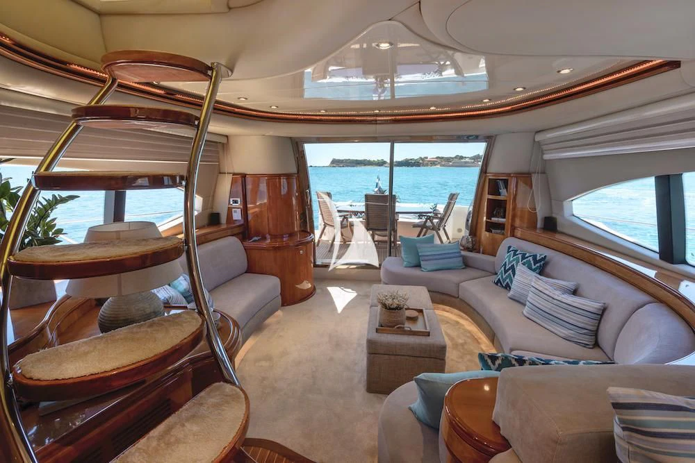 a living room with a large window aboard MANU Yacht for Charter