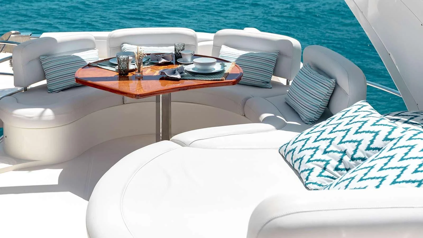 a table with chairs and a tray on it aboard MANU Yacht for Charter