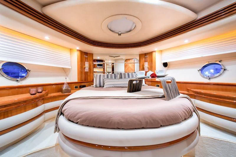 a room with a bed and a window aboard MANU Yacht for Charter