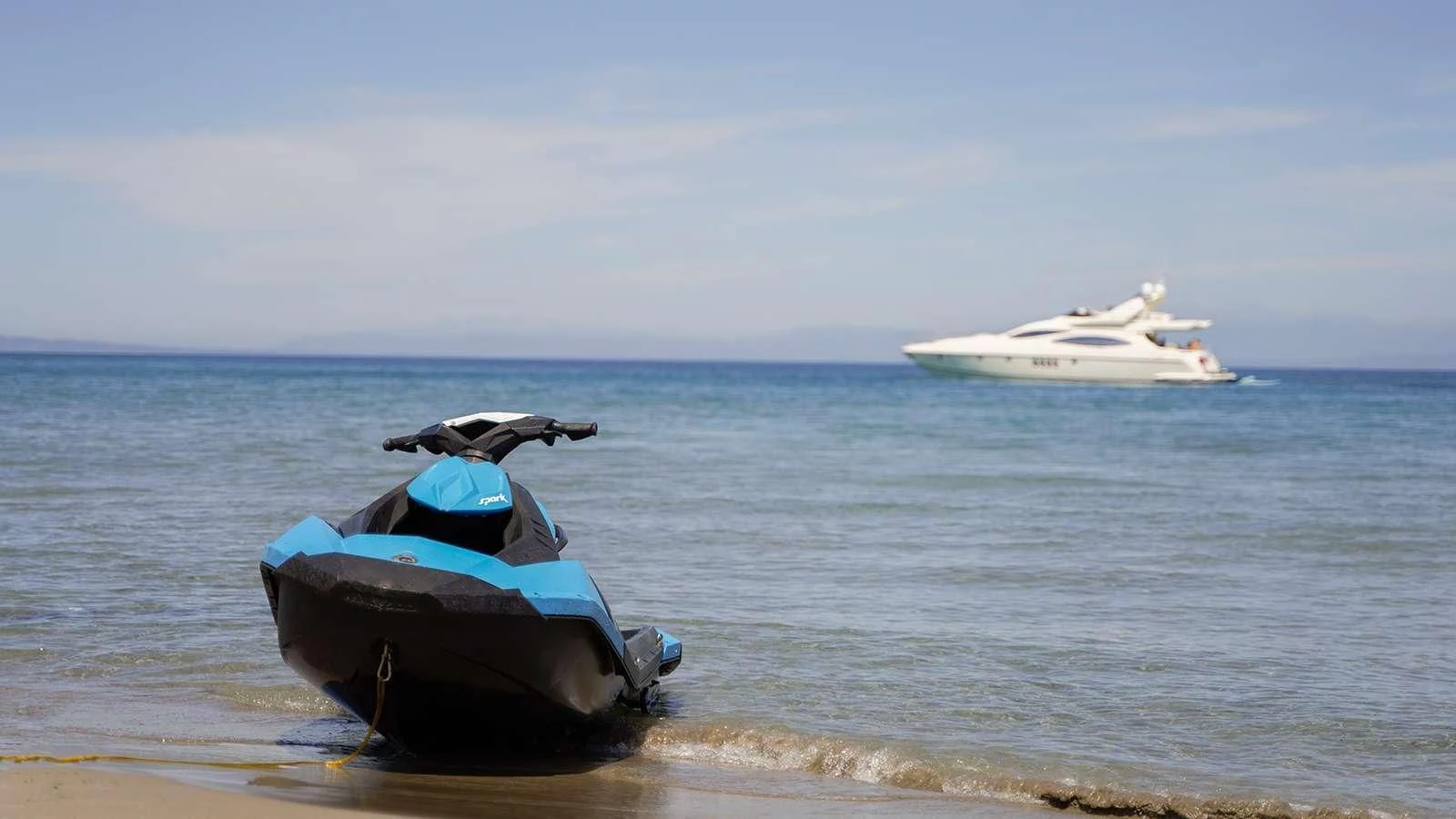a boat in the water with a boat in the background aboard MANU Yacht for Charter