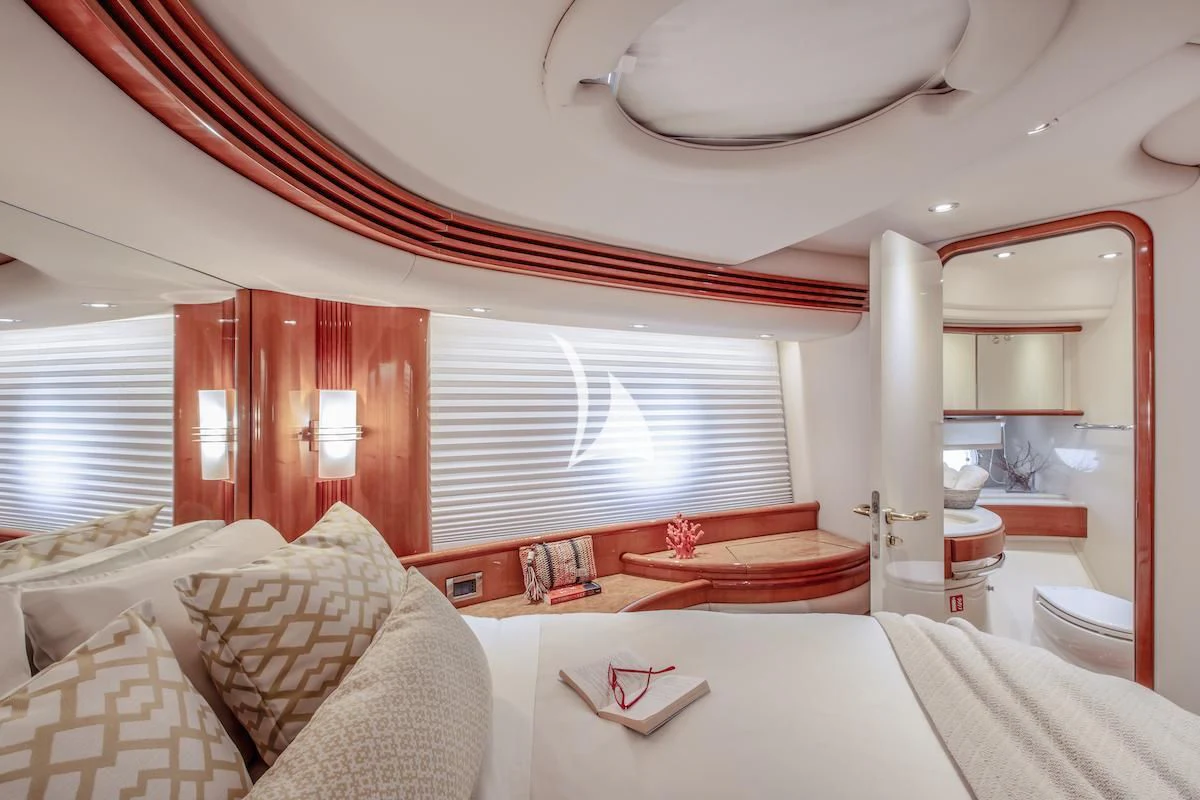 a room with a bed and a mirror aboard MANU Yacht for Charter