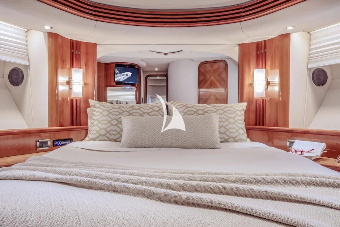 a bed with white sheets aboard MANU Yacht for Charter