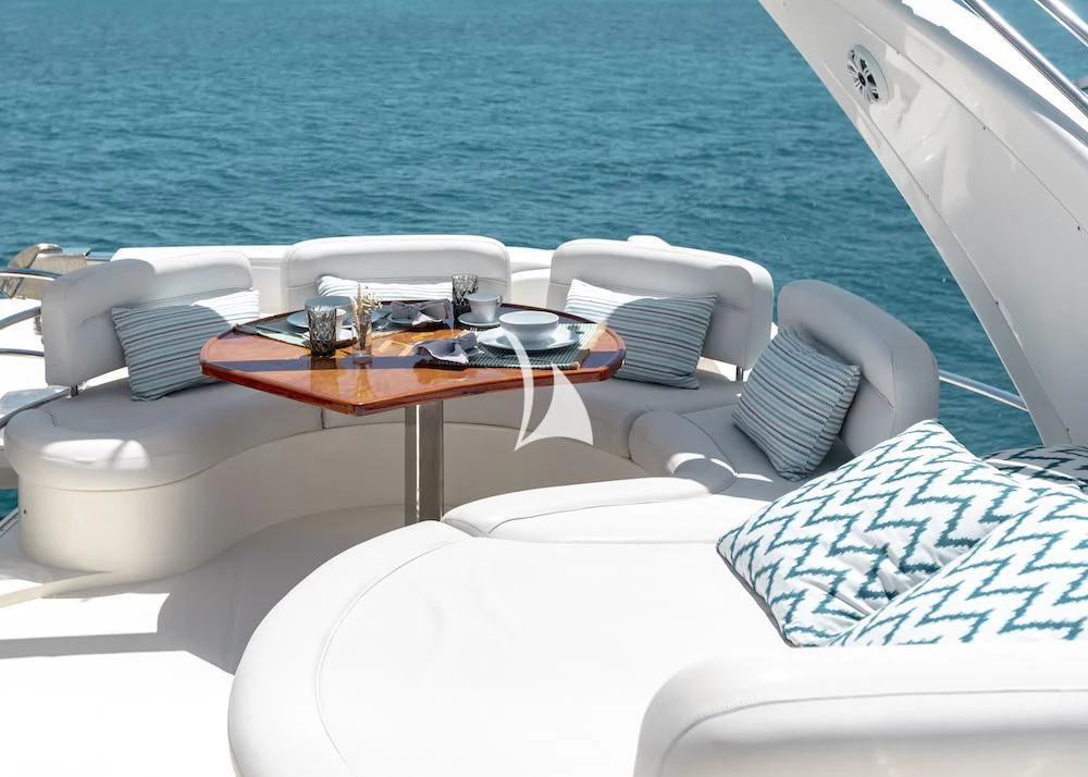 a room with a table and chairs aboard MANU Yacht for Charter