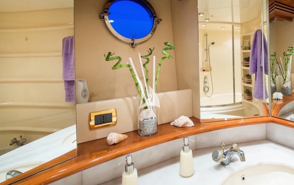 a bathroom with a vase of flowers aboard MANU Yacht for Charter