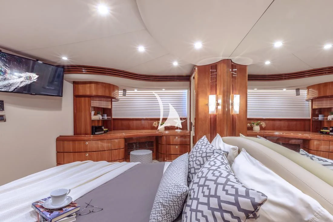 a bed with white sheets aboard MANU Yacht for Charter