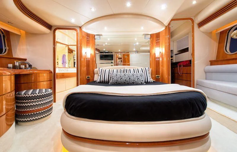 a large bedroom with a large mirror aboard MANU Yacht for Charter
