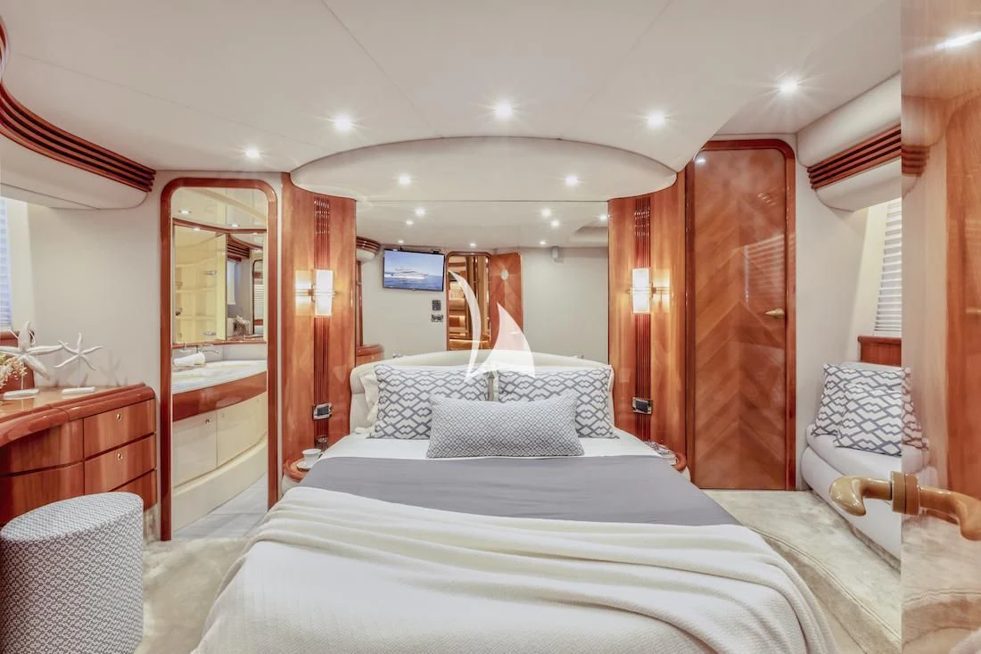 a room with a bed and a mirror aboard MANU Yacht for Charter