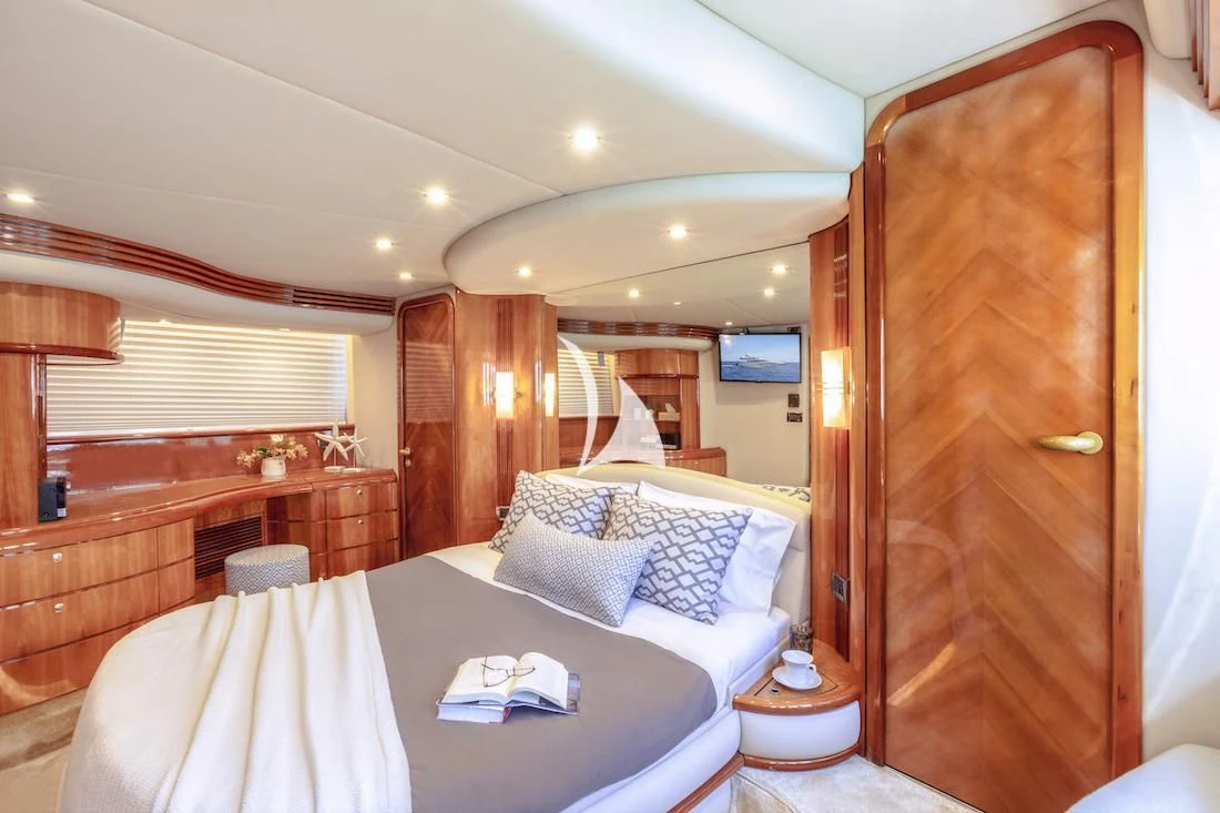 a hotel room with a bed and a mirror aboard MANU Yacht for Charter